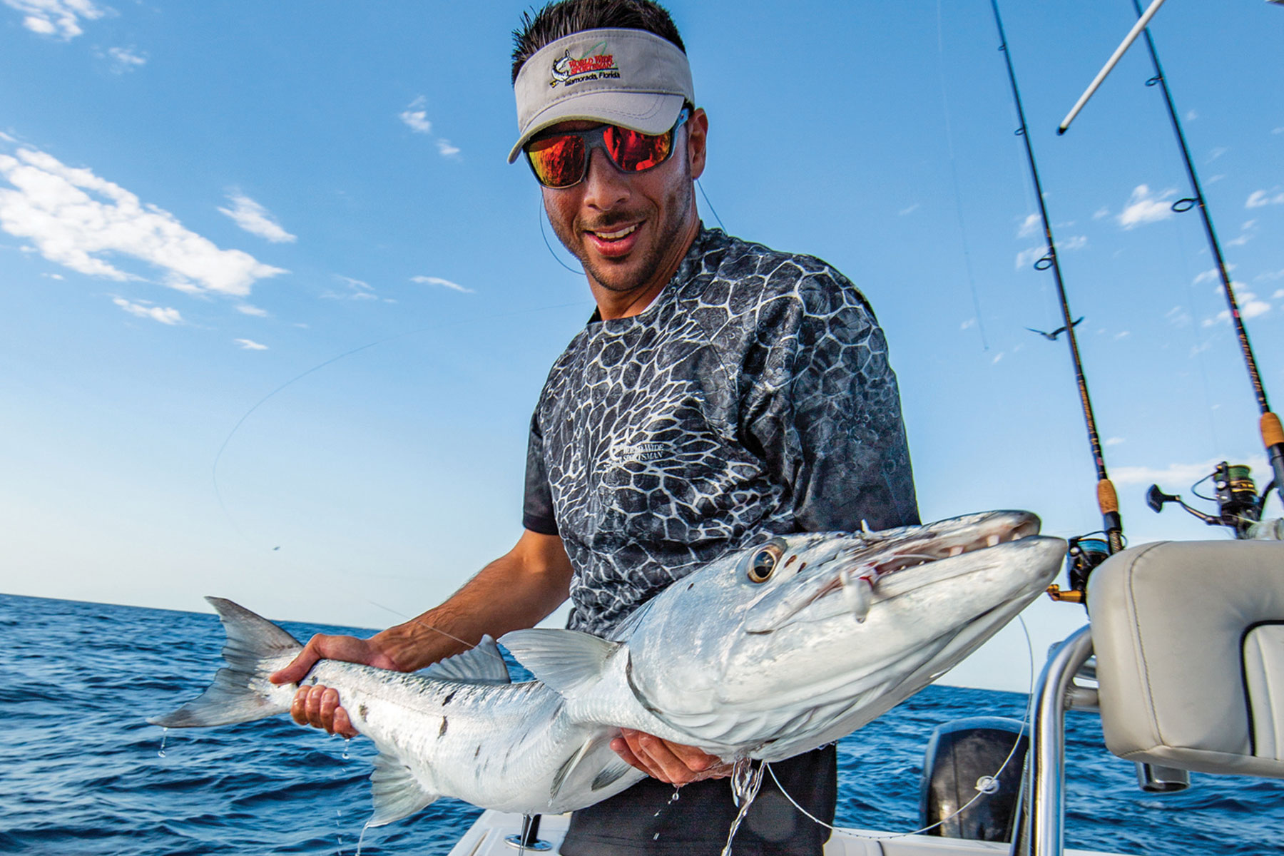 fisherman holding saltwater fish